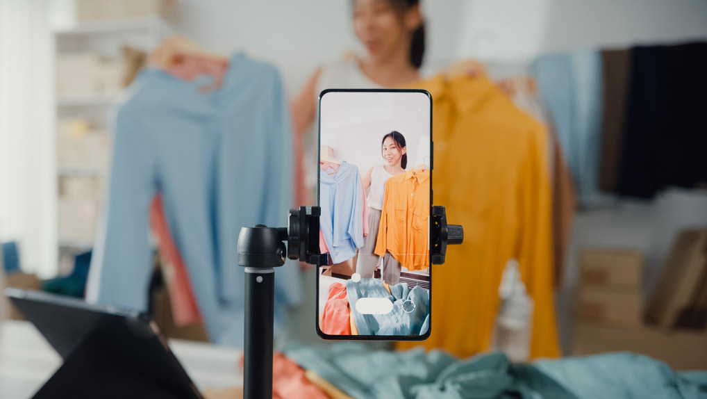 influencer showing off and reviewing clothes to her phone