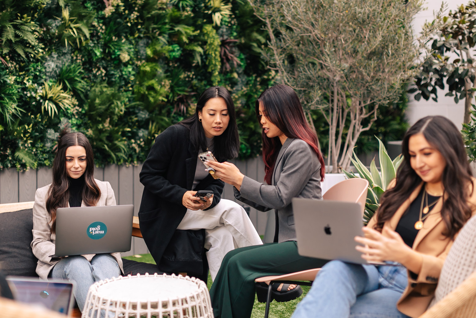 mari and gold team members working outside on phones and computers
