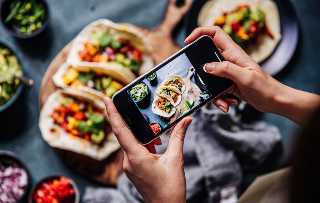 smarthphone taking pictures of spread of food